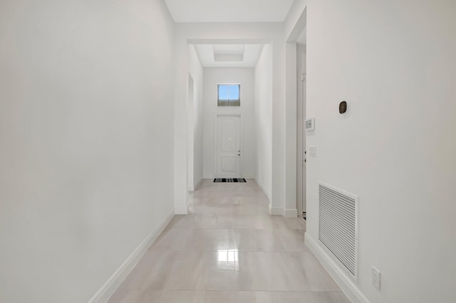 hall featuring light tile patterned floors