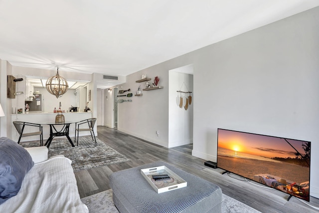 living room featuring hardwood / wood-style floors and an inviting chandelier