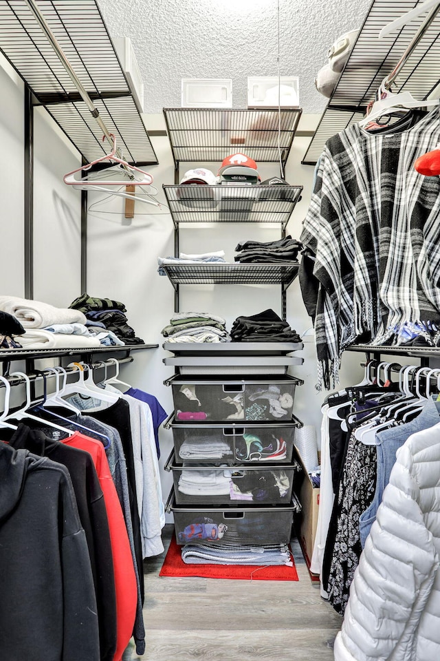 walk in closet featuring hardwood / wood-style flooring