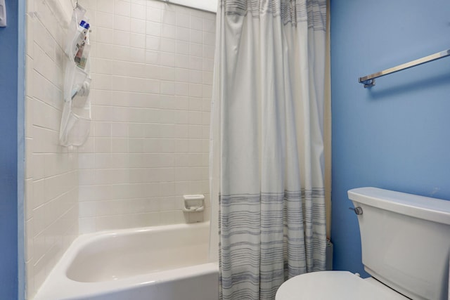 bathroom with shower / bathtub combination with curtain and toilet