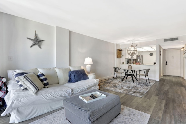 living room featuring wood-type flooring and a chandelier