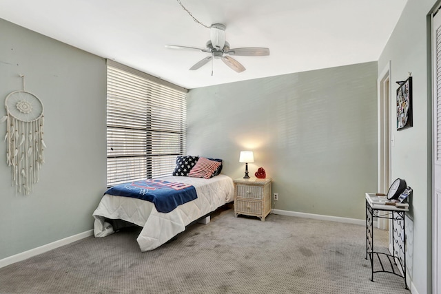 bedroom with ceiling fan and light carpet