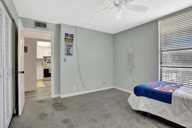 bedroom featuring light carpet and ceiling fan