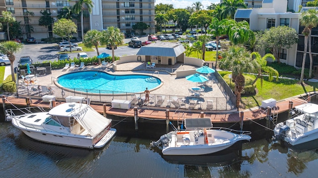 view of pool with a water view and a patio area