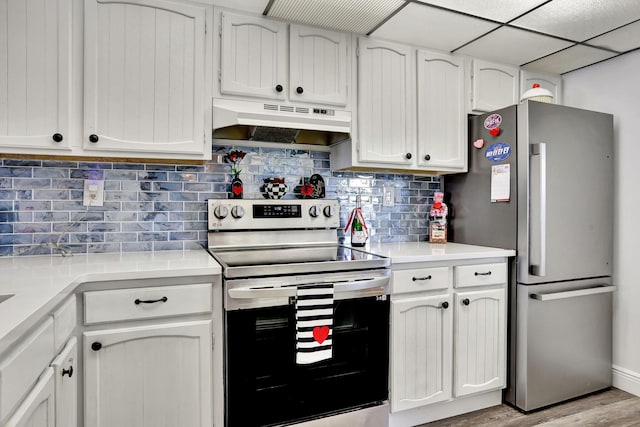 kitchen featuring tasteful backsplash, white cabinetry, appliances with stainless steel finishes, and light wood-type flooring