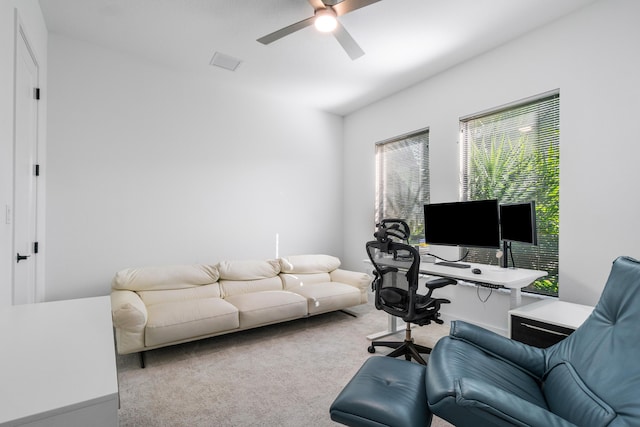 home office featuring ceiling fan and light carpet