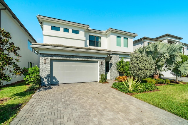 view of front of home featuring a garage and a front lawn