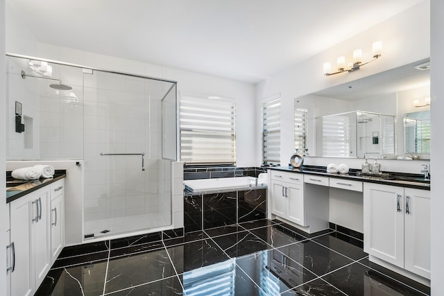 bathroom with vanity and separate shower and tub