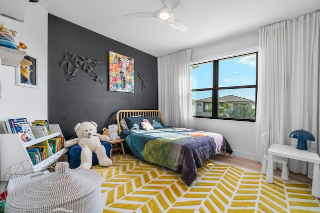 bedroom with ceiling fan and light wood-type flooring