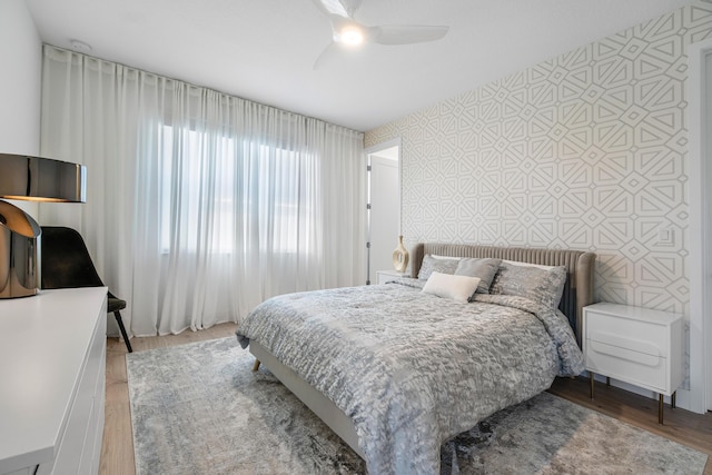 bedroom with ceiling fan and wood-type flooring