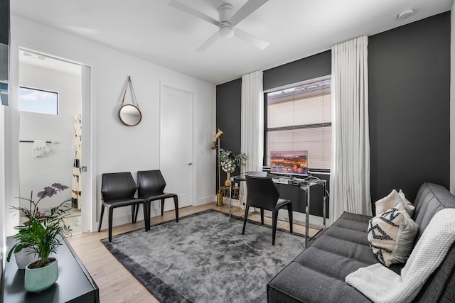 living room featuring hardwood / wood-style floors and ceiling fan