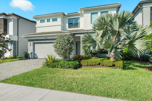 view of front of house with a garage and a front lawn