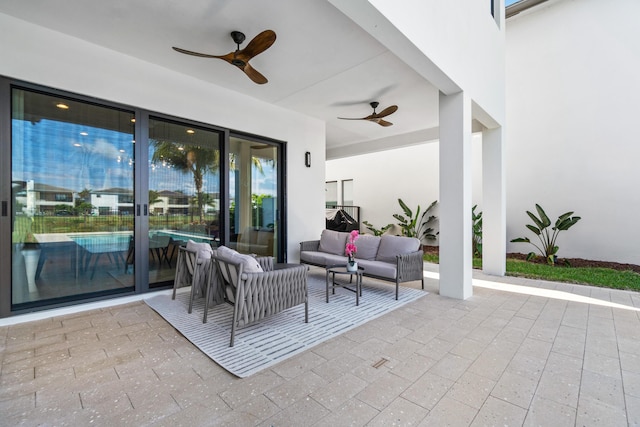 view of patio with an outdoor living space and ceiling fan