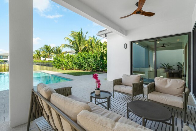 view of patio featuring ceiling fan, an outdoor living space, and a fenced in pool