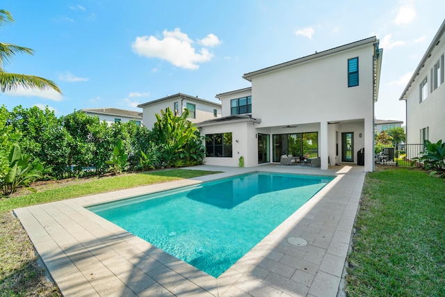 view of swimming pool with an outdoor hangout area, a lawn, a patio, and ceiling fan