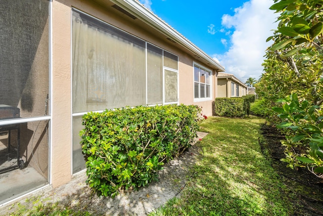 view of side of property with a yard