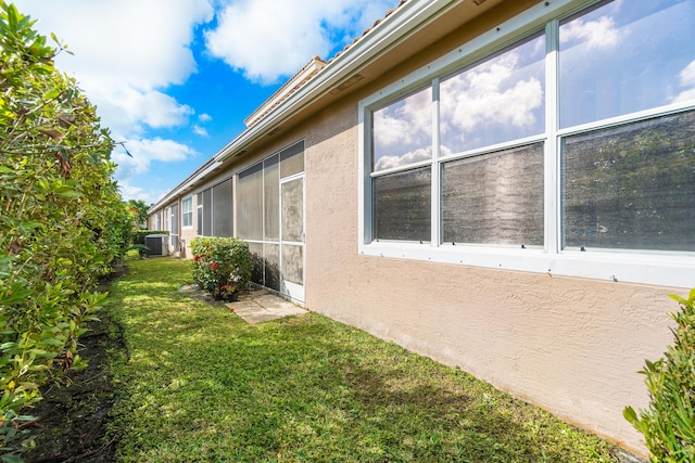 view of home's exterior with a yard and central air condition unit