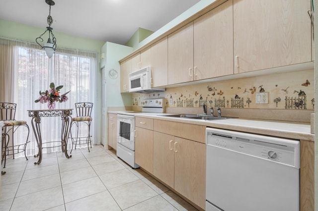 kitchen featuring hanging light fixtures, white appliances, sink, and light brown cabinets