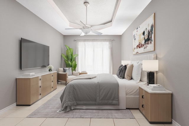 tiled bedroom featuring ceiling fan, a raised ceiling, and a textured ceiling