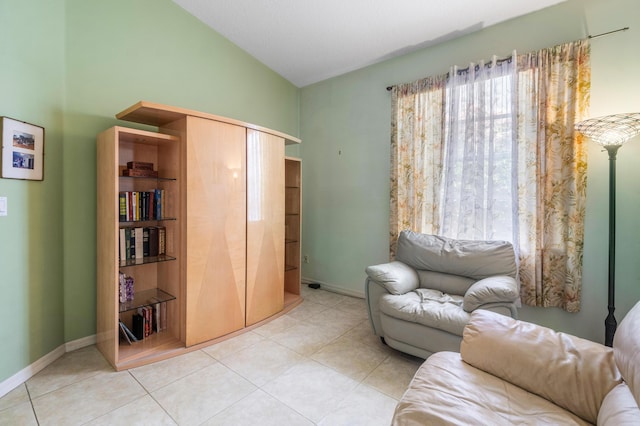 sitting room featuring light tile patterned floors and vaulted ceiling