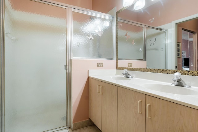 bathroom featuring an enclosed shower, vanity, and tile patterned floors