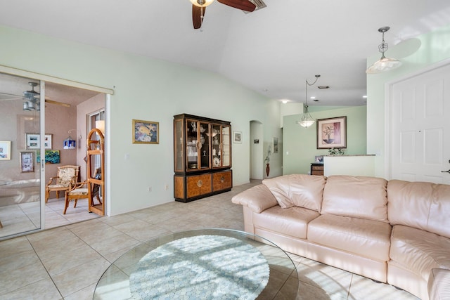 living room with light tile patterned flooring, ceiling fan, and lofted ceiling