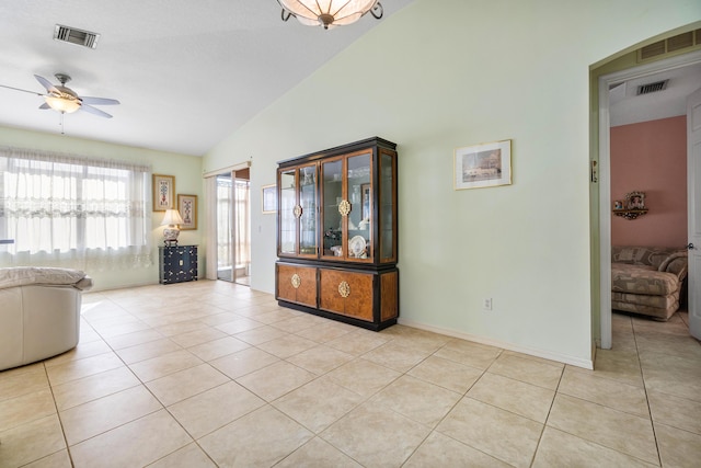 tiled living room with lofted ceiling and ceiling fan