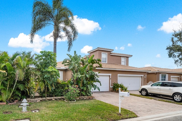 view of front of property with a garage and a front yard