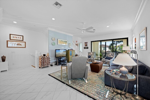 living room with ornamental molding and ceiling fan