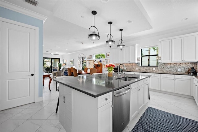 kitchen with sink, dishwasher, hanging light fixtures, white cabinets, and a center island with sink