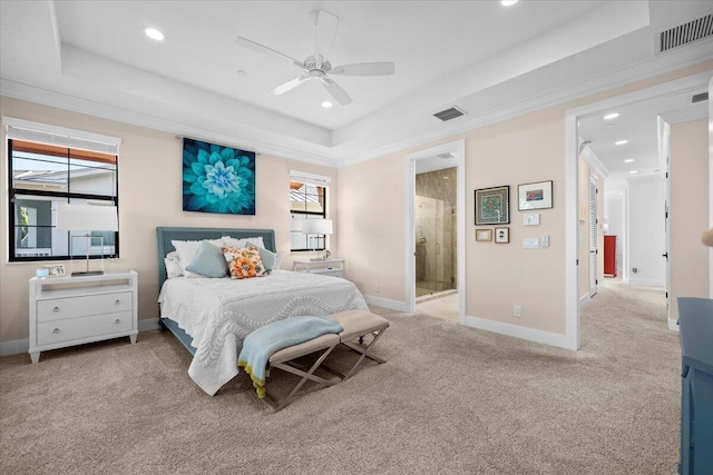 bedroom featuring a tray ceiling, ornamental molding, and light colored carpet