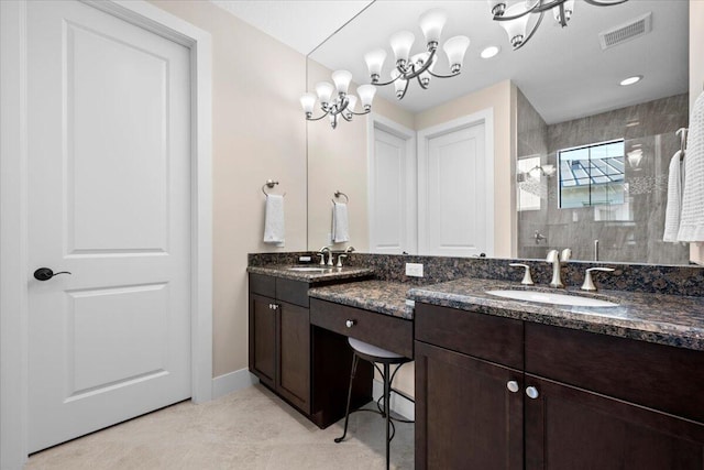 bathroom featuring an enclosed shower, vanity, and tile patterned flooring