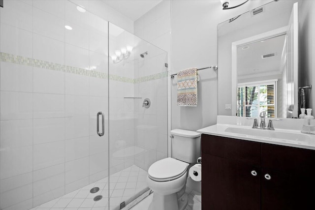 bathroom featuring vanity, a shower with door, ornamental molding, and toilet