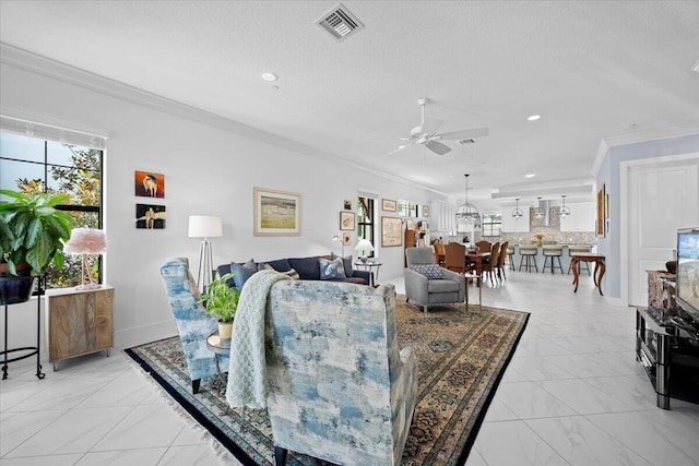 living room with ornamental molding, a textured ceiling, and ceiling fan