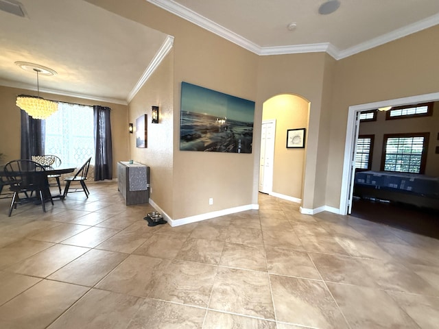 interior space featuring visible vents, baseboards, ornamental molding, light tile patterned floors, and arched walkways