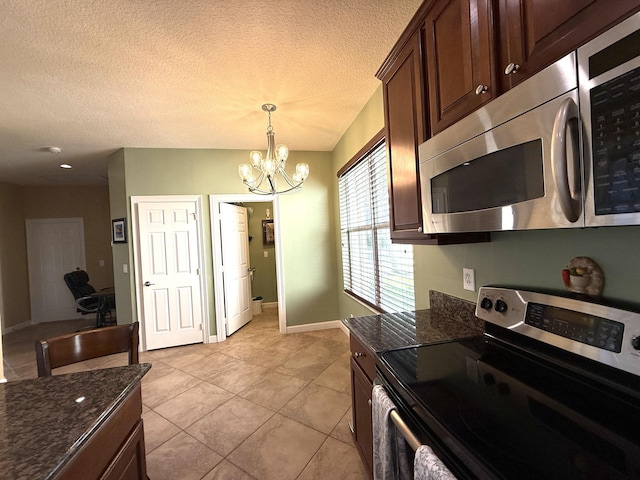 kitchen featuring a textured ceiling, dark brown cabinetry, and stainless steel appliances