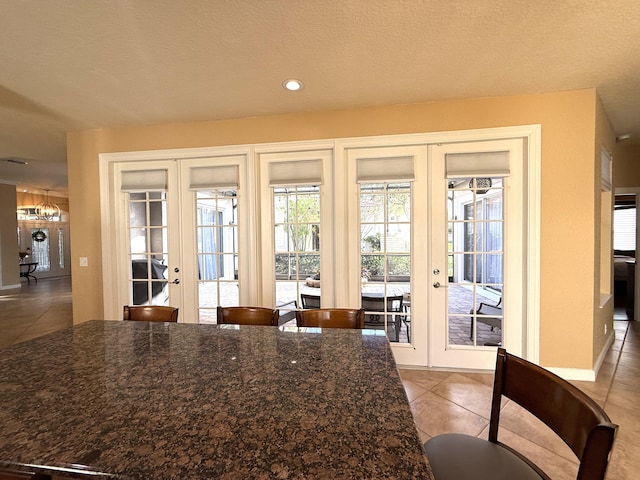 doorway featuring light tile patterned floors, recessed lighting, and french doors