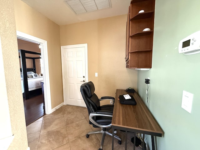 office featuring light tile patterned flooring, visible vents, and baseboards