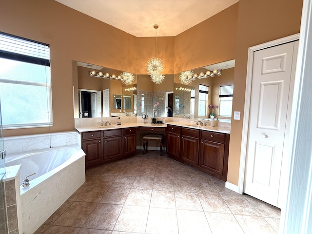 bathroom with a shower, a bath, vanity, and tile patterned flooring