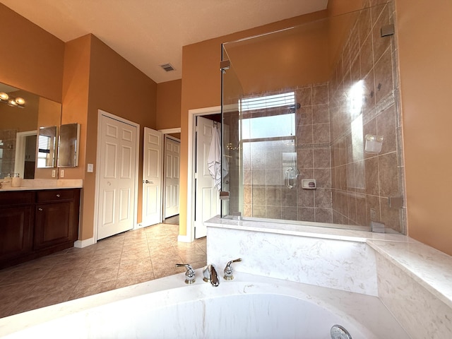 bathroom featuring vanity, visible vents, tiled shower, tile patterned floors, and a bath