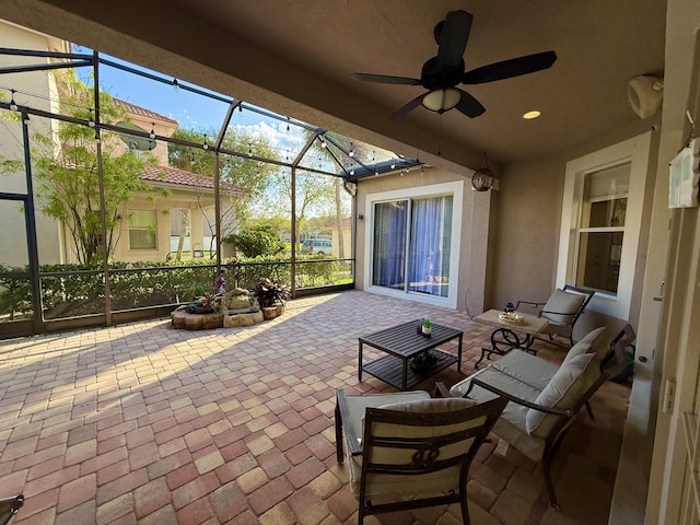 view of patio / terrace featuring a lanai and a ceiling fan