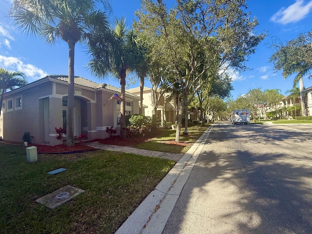 view of street with a residential view and curbs