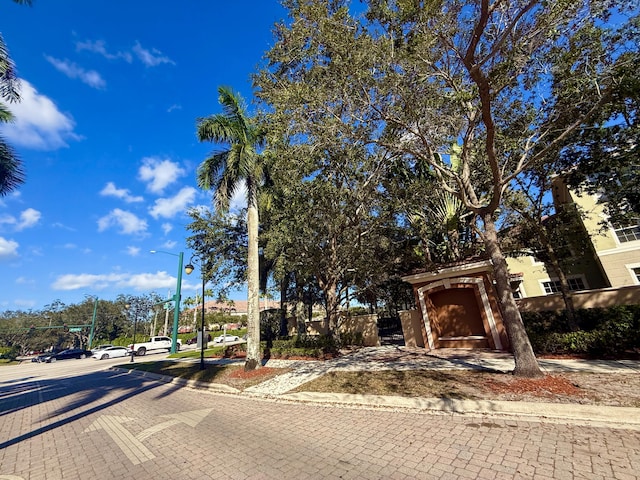 view of road featuring curbs, street lights, and sidewalks