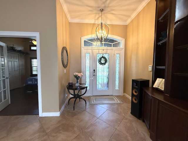 foyer entrance featuring light tile patterned floors, baseboards, a chandelier, and crown molding