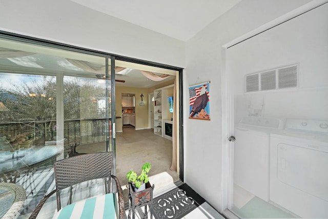 interior space featuring washer and dryer and a ceiling fan