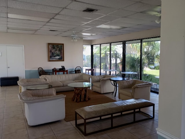 tiled living area with a paneled ceiling and visible vents