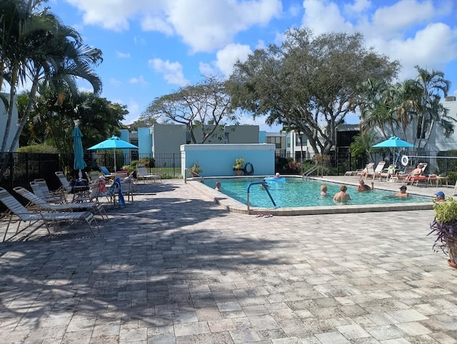 community pool featuring a patio and fence