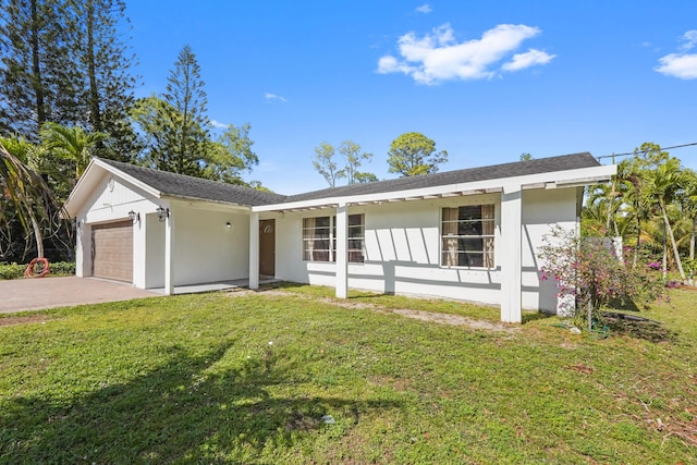 ranch-style home featuring a garage and a front lawn