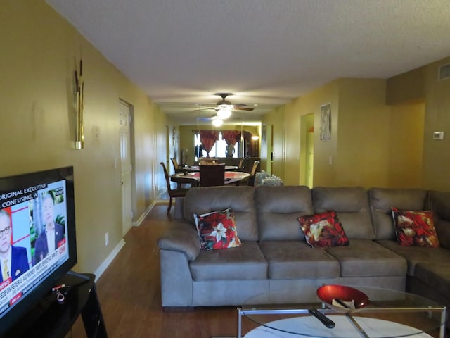 living room with hardwood / wood-style flooring and ceiling fan