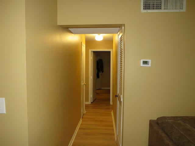 hall with light hardwood / wood-style flooring